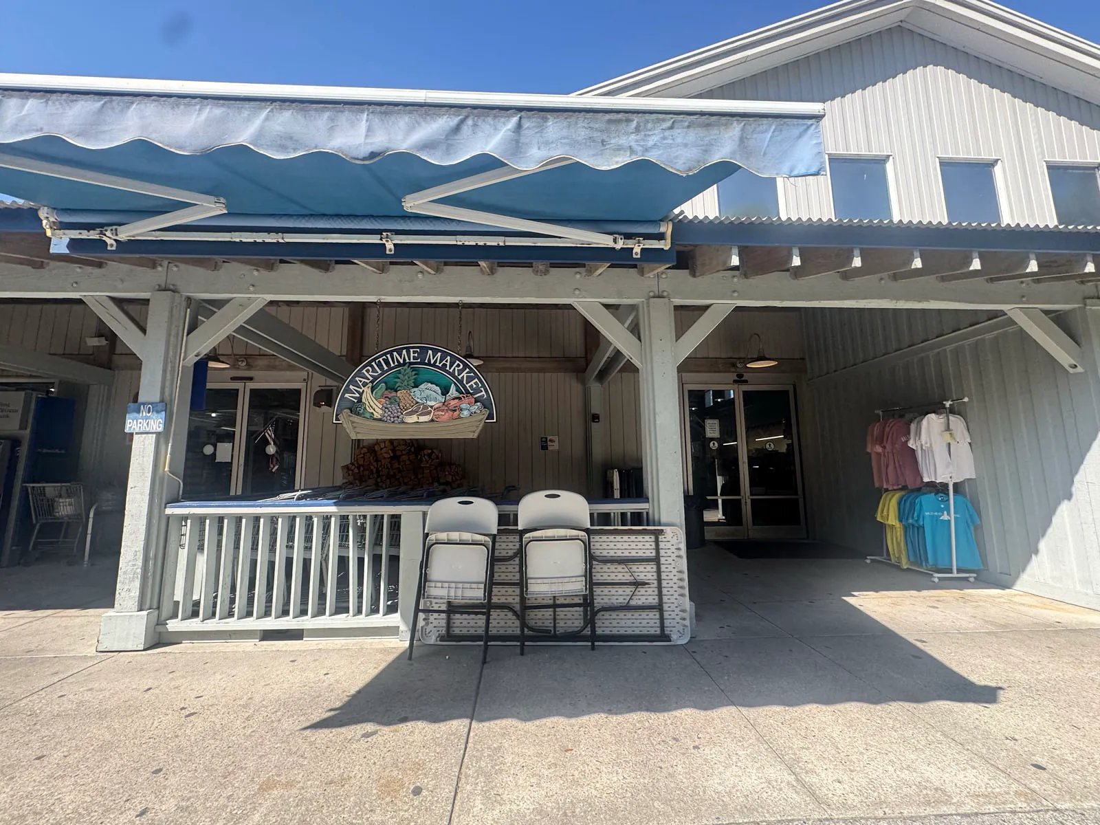 Maritime Market entrance under blue awning, hanging sign