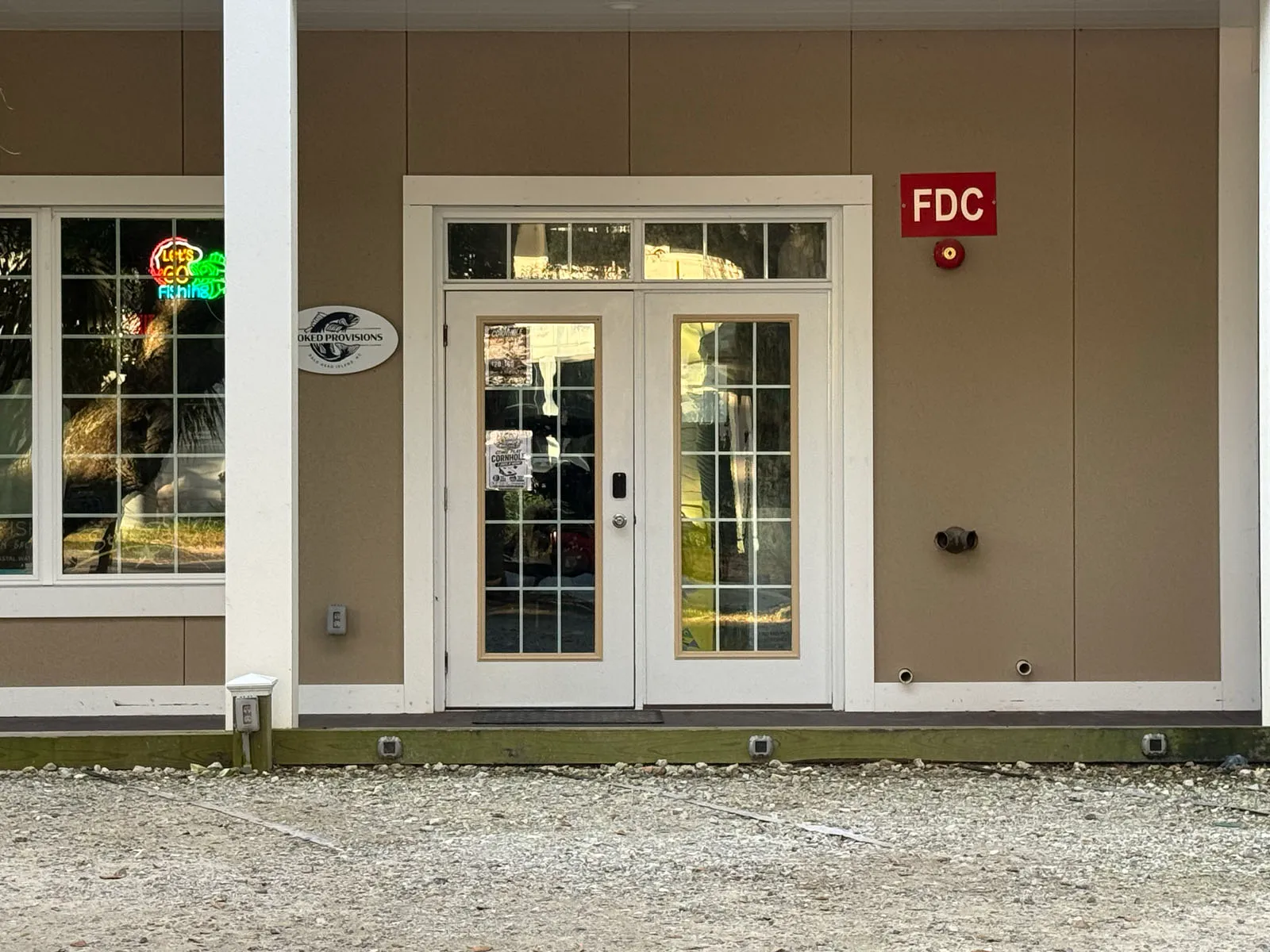 Stoked Provisions storefront entrance with neon sign