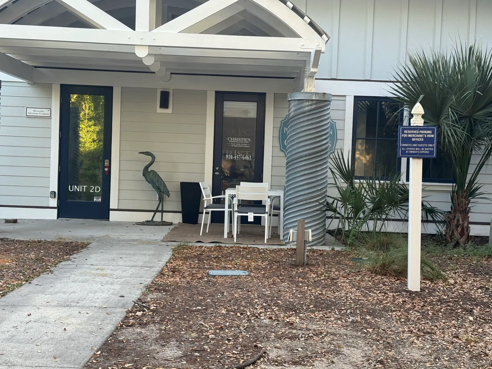 Christie's real estate office entrance with heron statue
