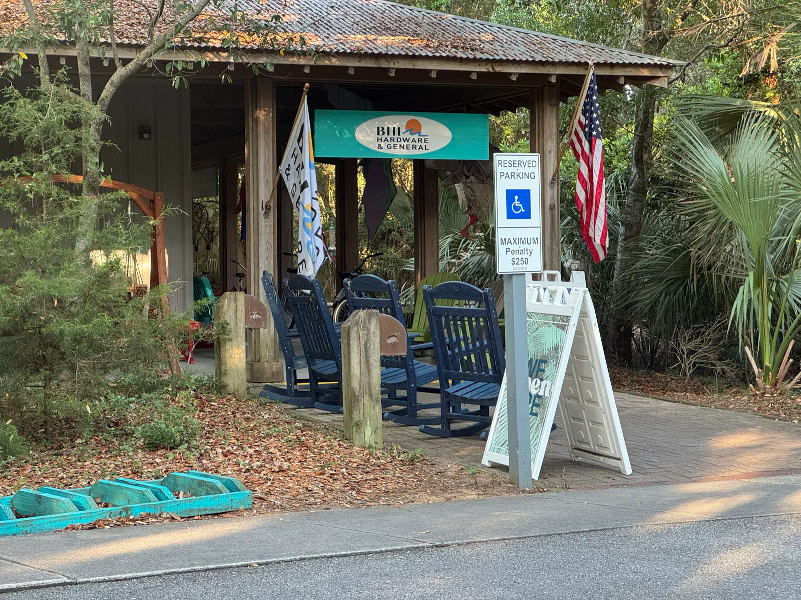 BHI Hardware & General store with rocking chairs and flag