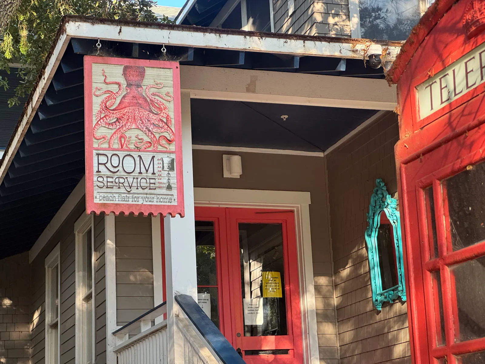 Room Service shop hanging octopus sign, red phone booth