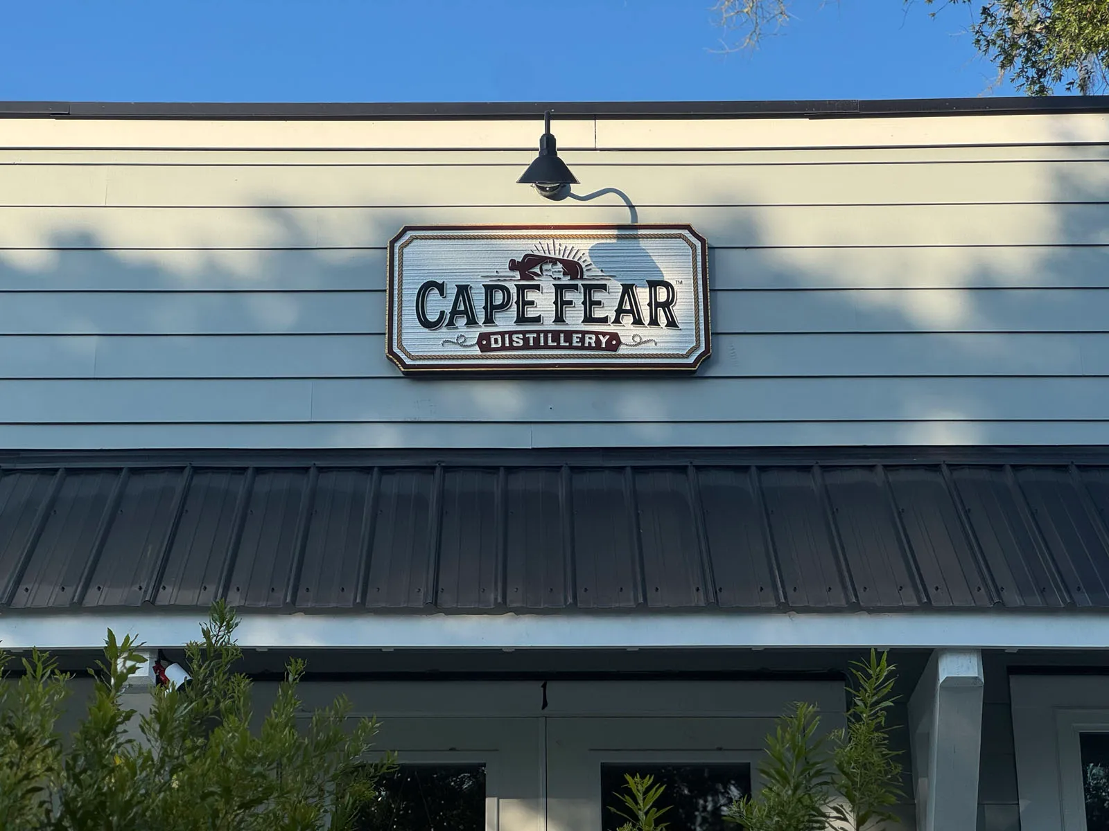 Cape Fear Distillery exterior sign against blue sky