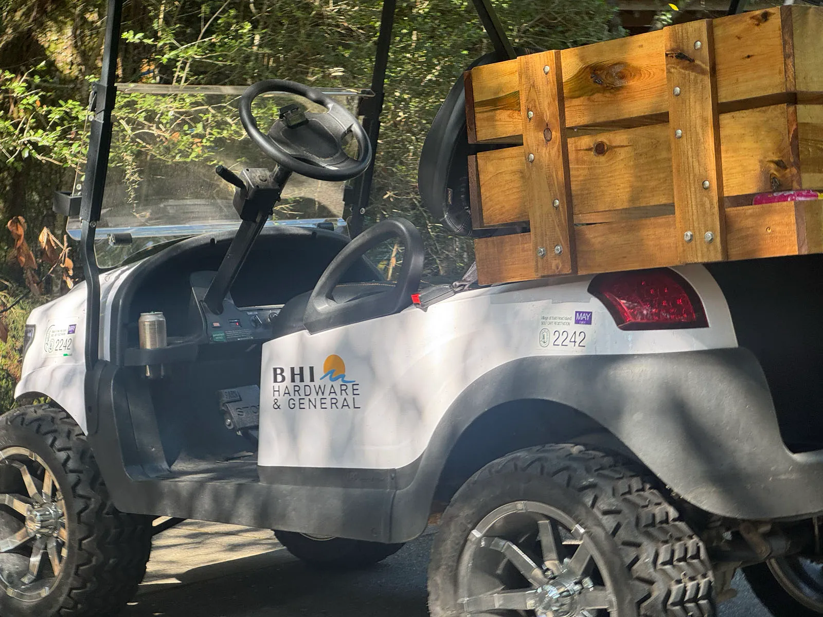 BHI Hardware branded golf cart with wooden cargo box
