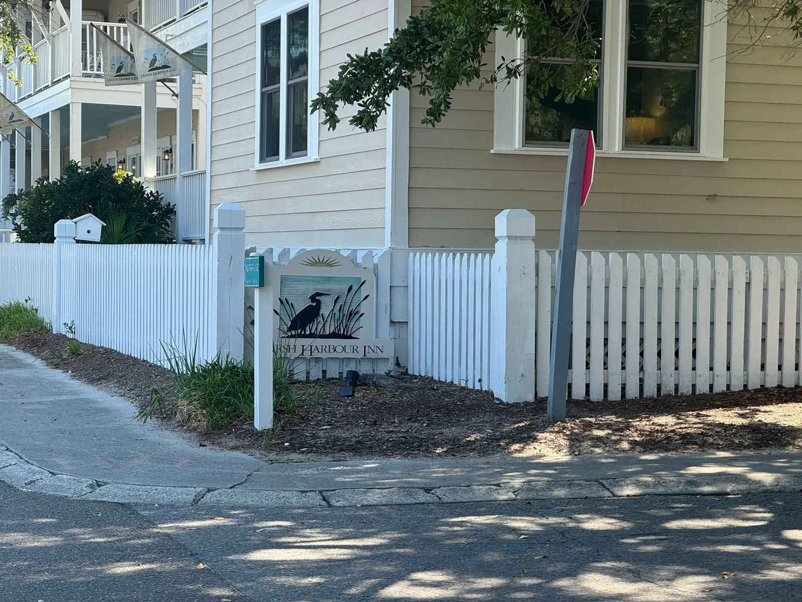 Marsh Harbour Inn sign and heron logo at picket fence