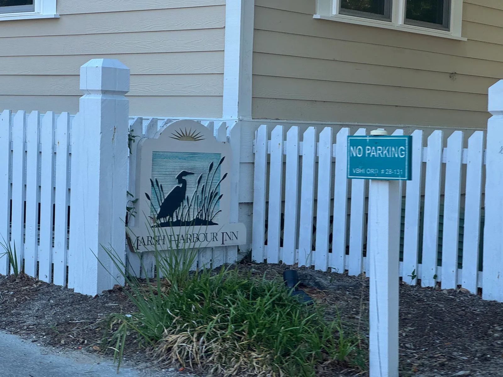 Close-up of Marsh Harbour Inn heron sign and No Parking sign