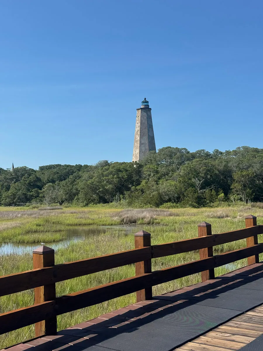 Old Baldy lighthouse over salt marsh from a boardwalk railing