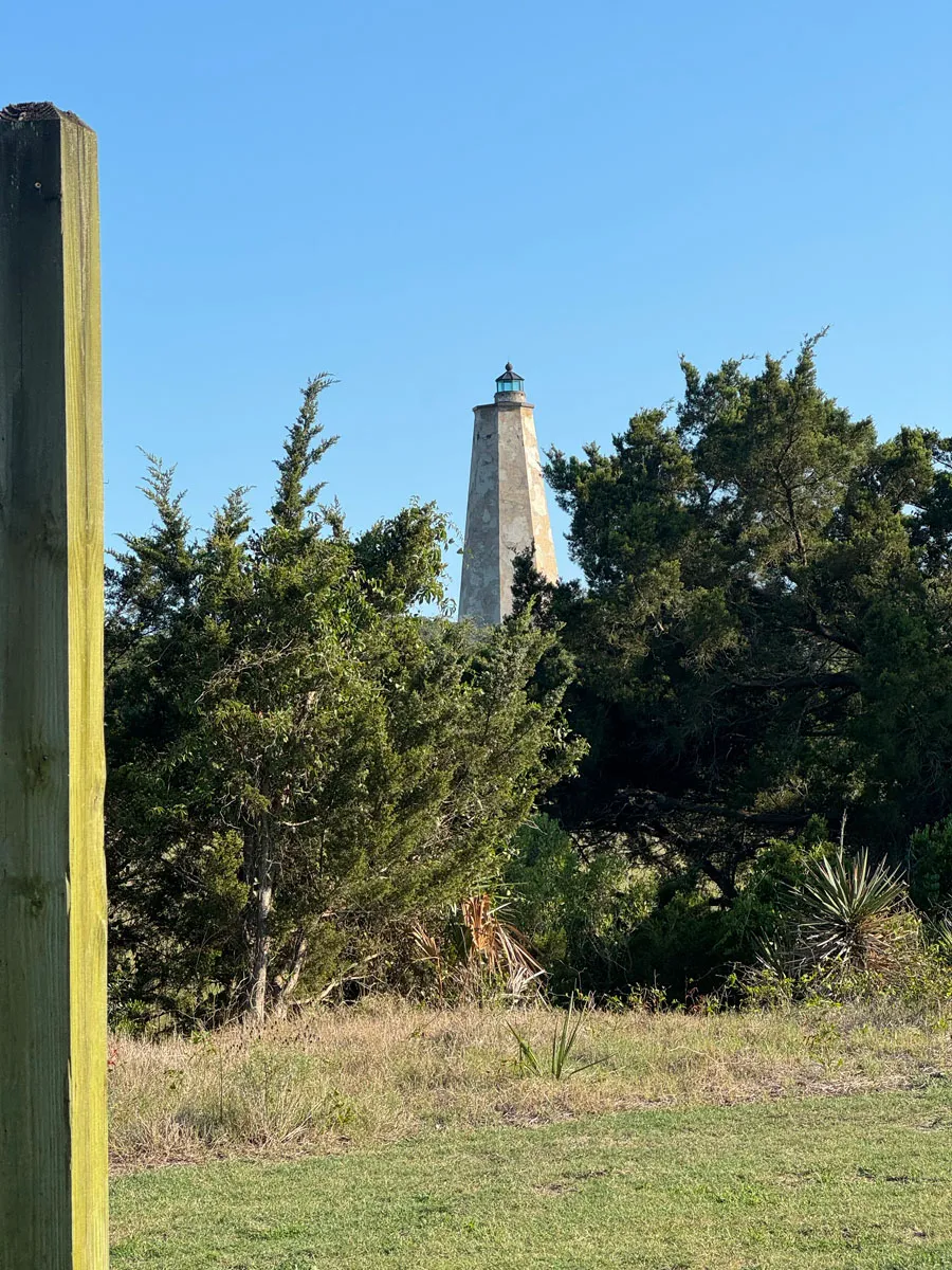 Old Baldy lighthouse rising above cedar trees