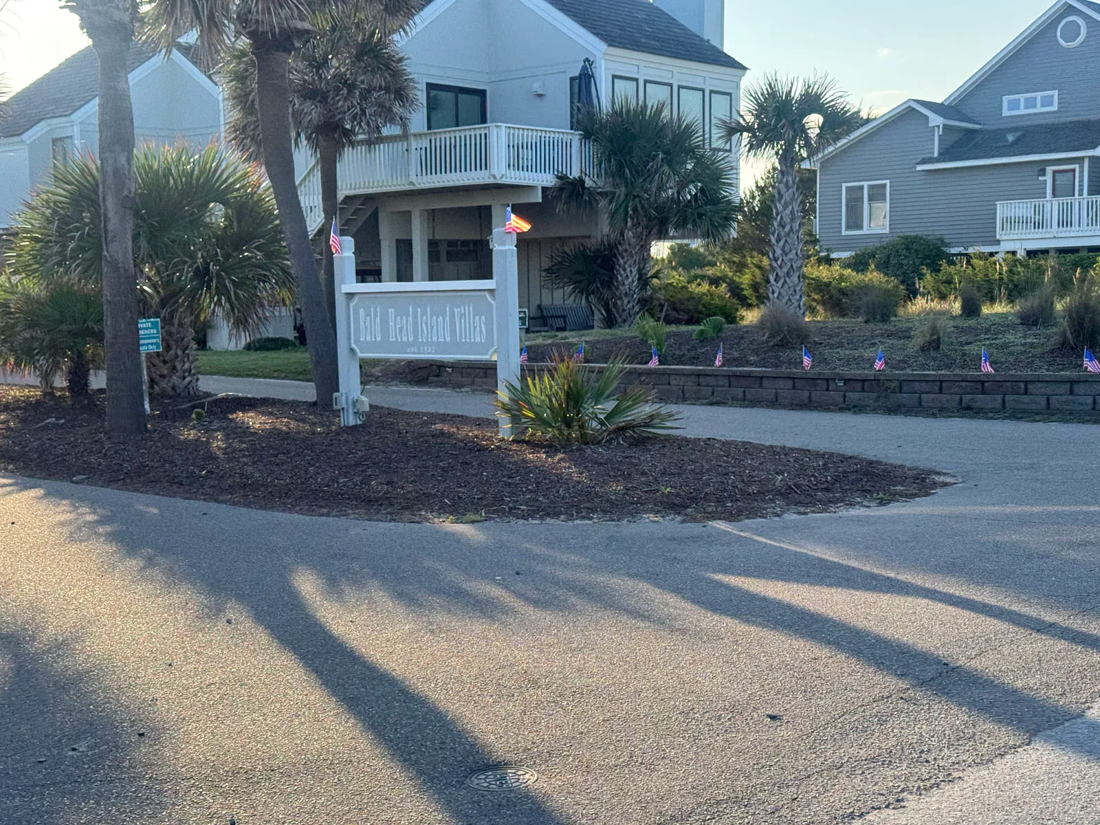 Bald Head Island Villas entrance sign with palms and homes