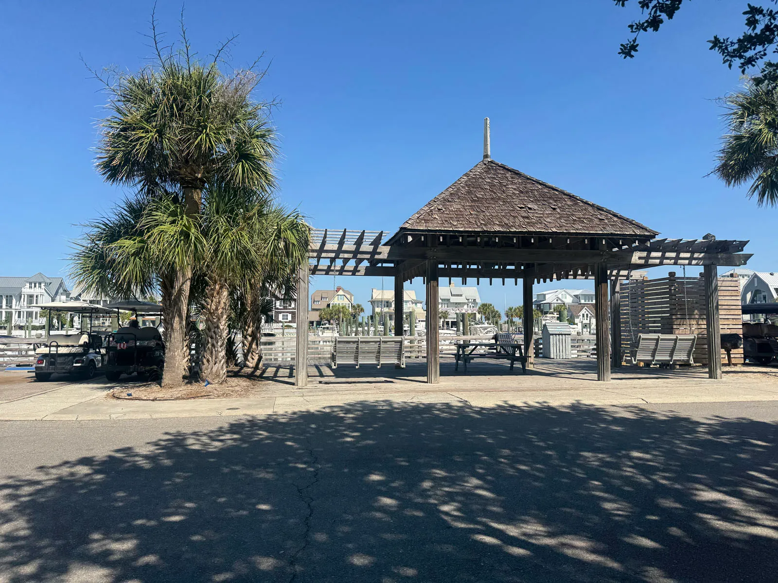 Waterfront gazebo pavilion and pergola at marina with palm